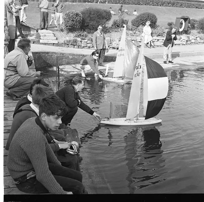 : People with model sailing boats on a pond : People with model sailing boats on a pond