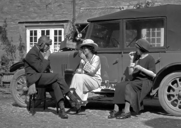 Framed Print : Three people picnicking at the side of a car Framed Print : Three people picnicking at the side of a car