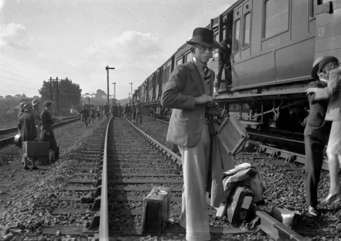 Framed Print : People on a railway track alongside a train Framed Print : People on a railway track alongside a train