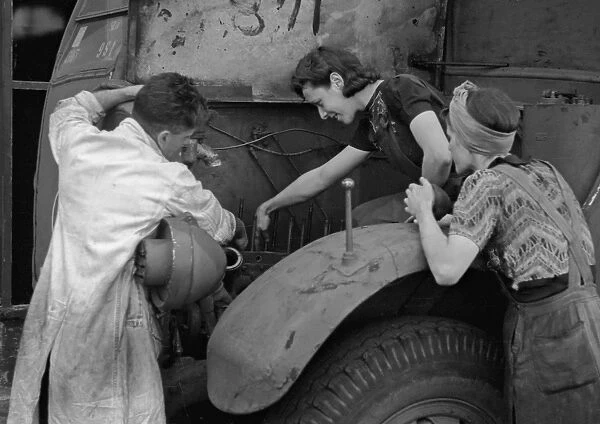 People repairing a vehicle