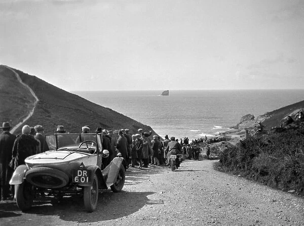 People on road sloping down to the sea