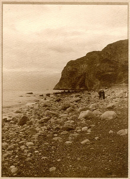 Two people on a rocky beach, North Wales