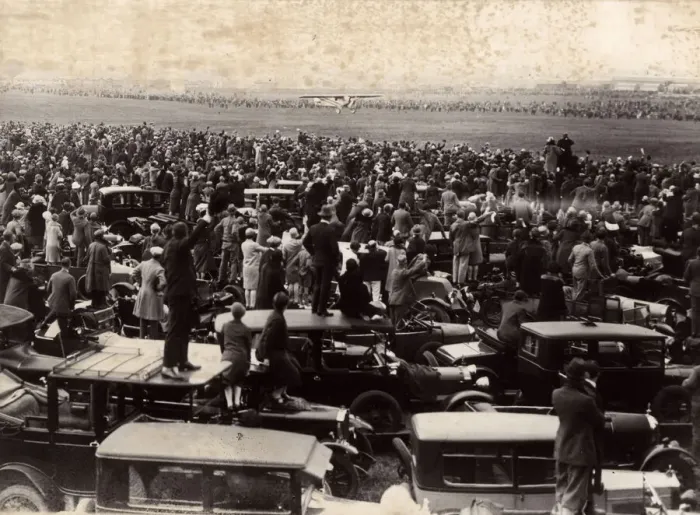Framed Print : People standing on car roofs to see a plane landing Framed Print : People standing on car roofs to see a plane landing