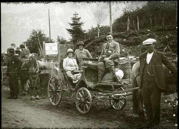People on a trip in two horse-drawn carriages