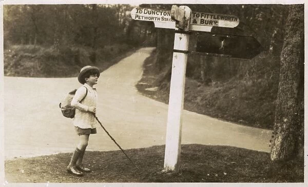 Petworth - Young boy checking his directions on a signpost