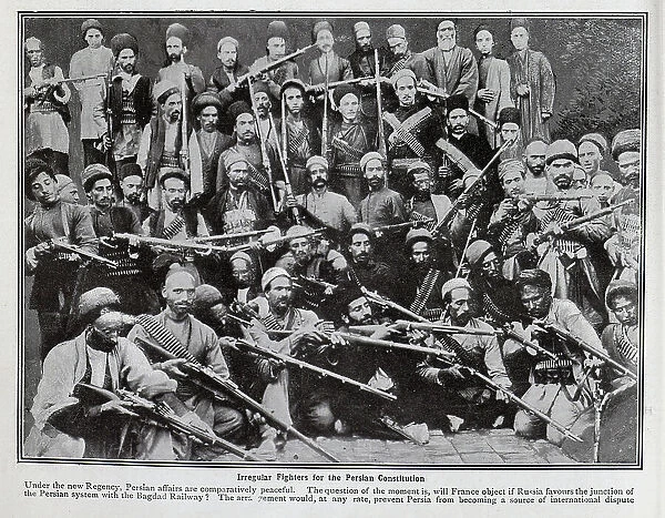 Photograph of a large group of armed men, captioned, Irregular fighters for the Persian Constitution'. With description, Under the new Regency, Persian affairs are comparatively peaceful