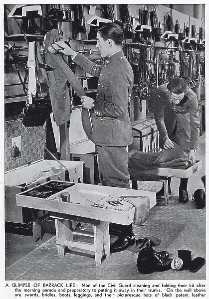 Photograph showing two Civil Guardsmen cleaning their kit in their barracks, Spain, 1936. The Civil Guard were a cross between a military unit and a police force, who worked to maintain peace and order in Spain in both times of war and peace