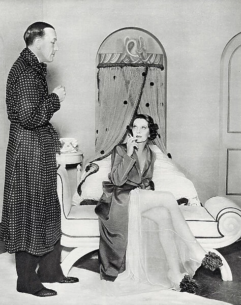 Photograph showing Noel Coward (1899-1973) and Gertrude Lawrence (1898-1952) starring in Coward's repertory Tonight at Seven Thirty, which included the piece Shadow Play, Manchester, 1935. Date: 1935