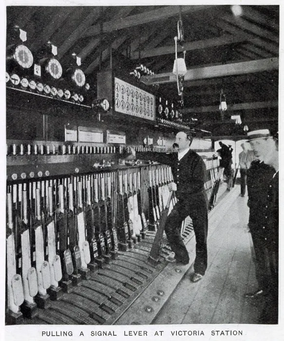 Framed Print : Photograph showing the signalman in the act of pulling a signal lever to allow a train to enter one of the platforms. Date: 1907 Framed Print : Photograph showing the signalman in the act of pulling a signal lever to allow a train to enter one of the platforms. Date: 1907