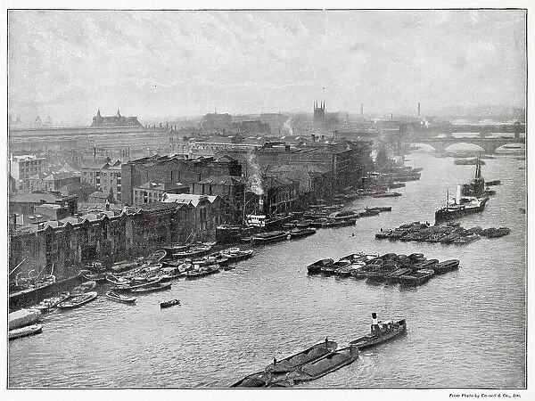 Photograph taken from Tower Bridge of the South Bank of the River Thames at high level. London Bridge, the viaduct which carries the South Eastern and Chatham Railway across the stream from Cannon Street Station