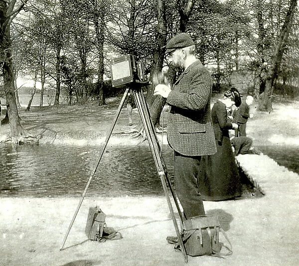 Photographer in a park with wooden camera on tripod