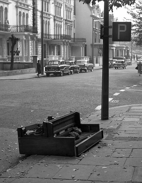 Piano abandoned on a street in Paddington, London