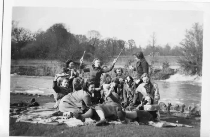 Framed Print : Picnic group in coats on rugs