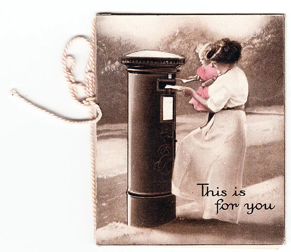 Pillar box with woman and child posting a letter