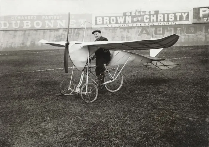 Framed Print : Pilot Sitting on Bi-Cycle Aircraft with Adverts in the ? Framed Print : Pilot Sitting on Bi-Cycle Aircraft with Adverts in the ?