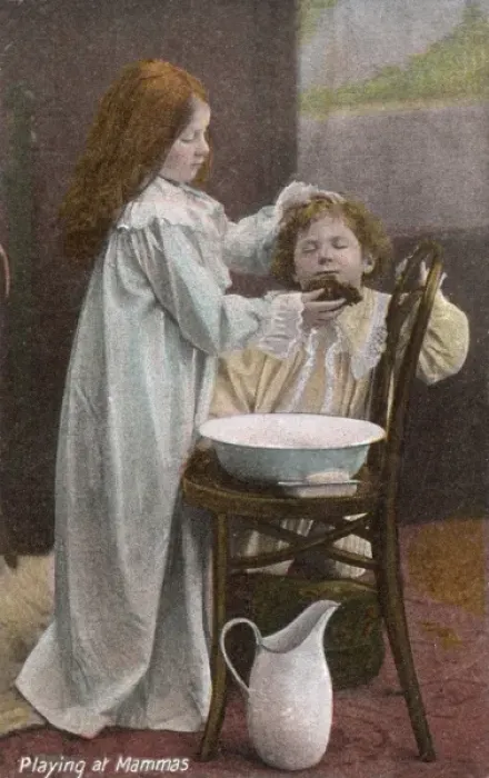 Framed Print : Playing at Mammas -- girl washes boys face Framed Print : Playing at Mammas -- girl washes boys face