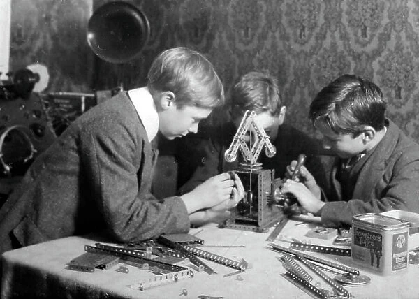 Playing with Meccano, possibly 1920s