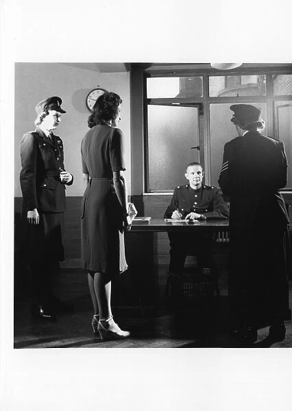 Police officers with woman in police station, London