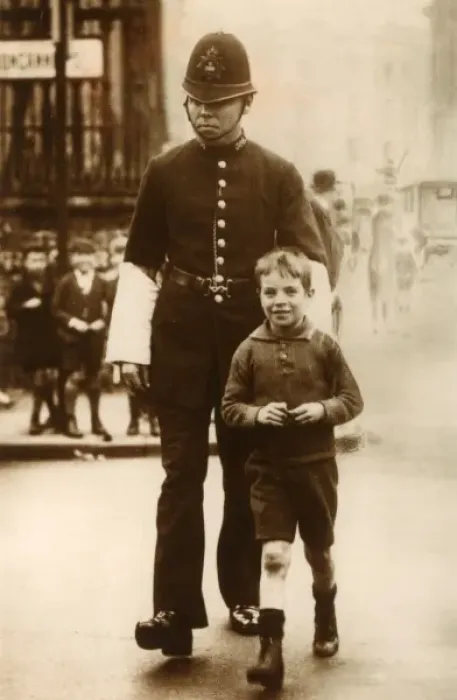 Framed Print : Policeman helping a young boy cross the road Framed Print : Policeman helping a young boy cross the road