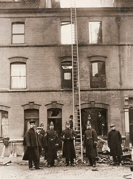 Policemen guarding house in Sidney Street, East London