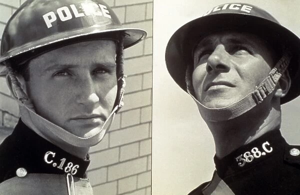 Policemen in wartime tin helmets