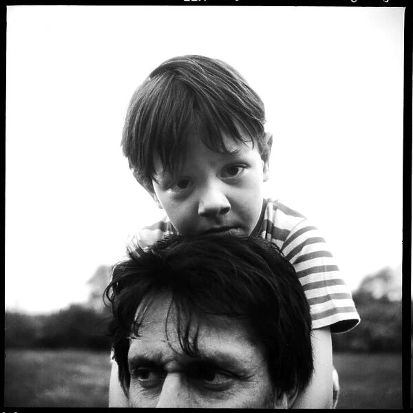 Portrait of a small boy on his fathers shoulders
