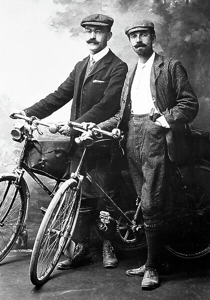 Portrait studio photo of cyclists, early 1900s
