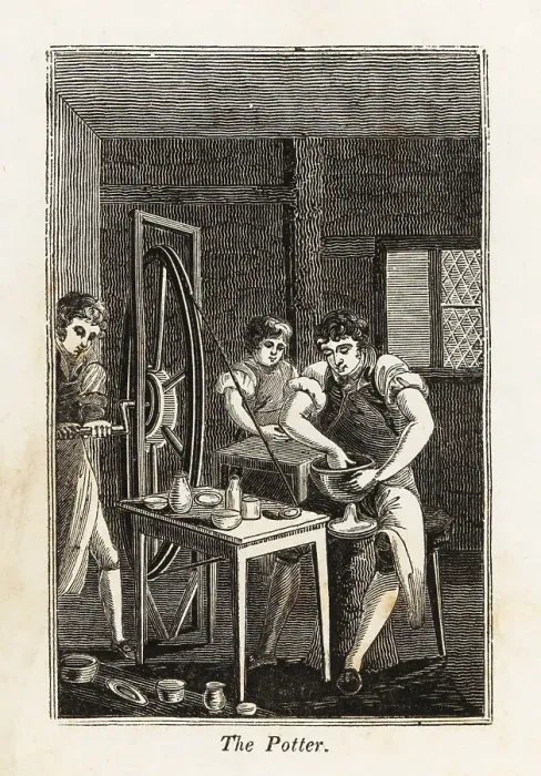 Framed Print : Potter in apron shaping a clay bowl in a workshop Framed Print : Potter in apron shaping a clay bowl in a workshop