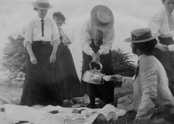 Pouring tea at a picnic