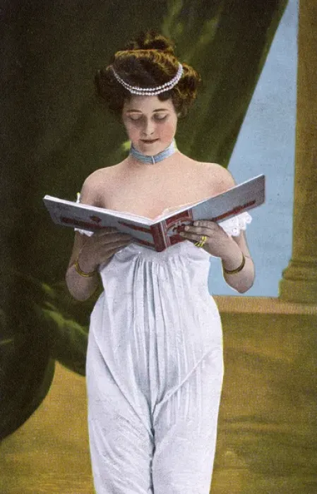 Framed Print : Pretty girl in white dress looking through photograph album Framed Print : Pretty girl in white dress looking through photograph album