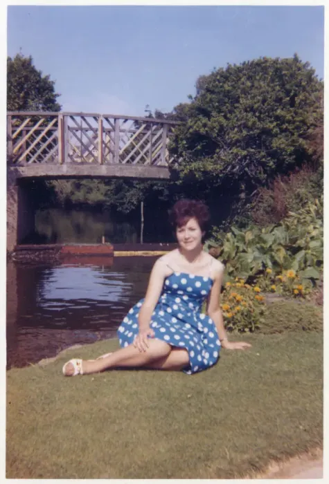 Framed Print : Pretty Young lady in a blue and white dress in a public park Framed Print : Pretty Young lady in a blue and white dress in a public park