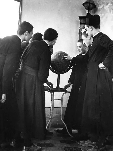 Priests Studying Globe