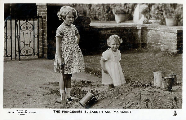 Princesses Elizabeth and Margaret playing in a sandpit