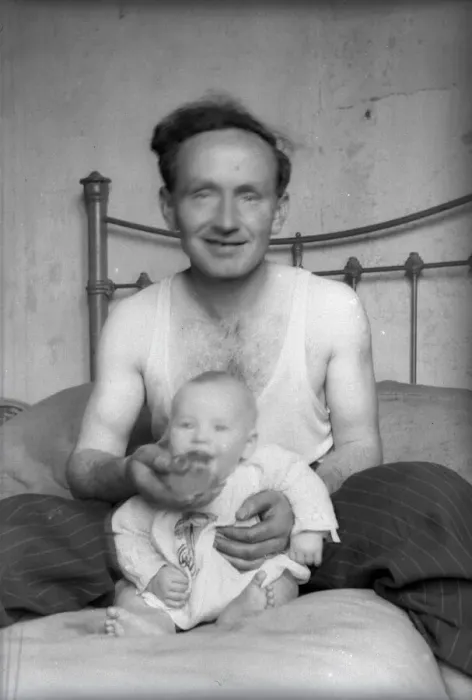 Framed Print : Proud Father sitting in bed with his young baby Framed Print : Proud Father sitting in bed with his young baby