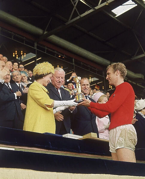 Queen Elizabeth II presents Bobby Moore with World Cup