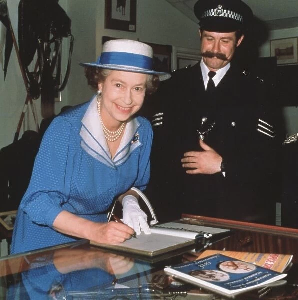 Queen Elizabeth II signing the visitors book