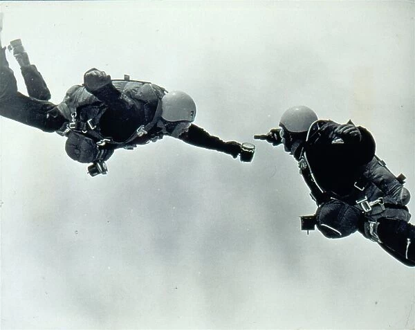 RAF parachutists pouring beer while in freefall. Date: 1960s