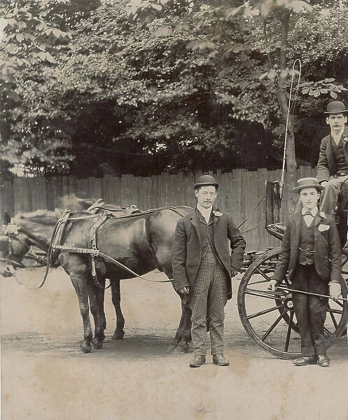 Three rather raffish horse- drawn cab drivers pose for a photograph during a quiet moment in between driving jobs. Date: 1890s