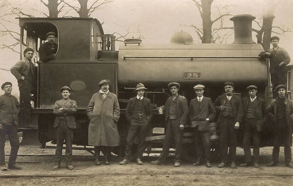 Railway workers pose with steam engine