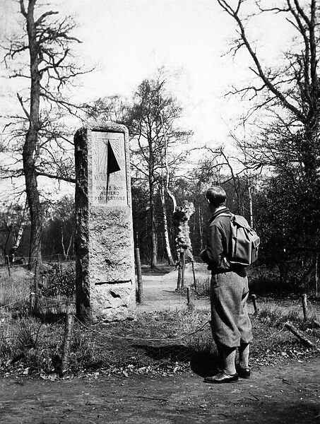 A rambler in plus fours reads the inscription on the sundial monument to daylight saving