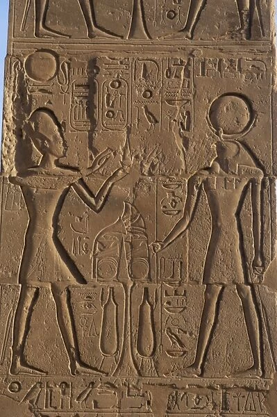 Relief depicting a Pharaoh making offerings to the god Ra. R