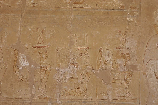 Reliefs depicting a kneeling woman and man with a child