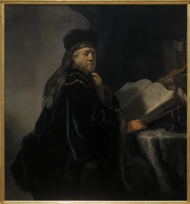 Framed Print : Rembrandt van Rijn (1606-1669). A Scholar in his study or A Framed Print : Rembrandt van Rijn (1606-1669). A Scholar in his study or A