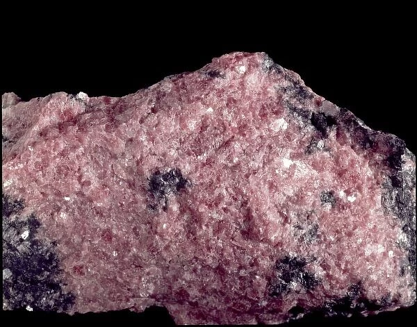 Rhodonite. A pink specimen of rhodonite (manganese iron magnesium calcium silicate)