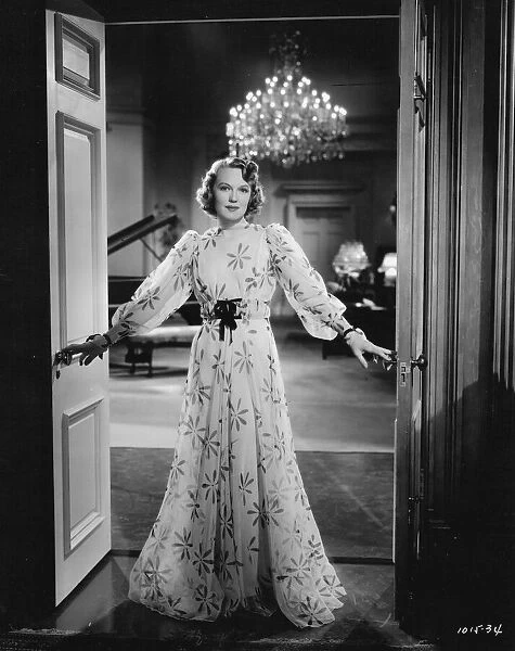 Rita Johnson wearing an evening gown designed by Dolly Tree