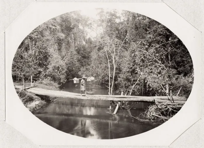 Framed Print : River scene, porter crossing a bridge, Madagascar Framed Print : River scene, porter crossing a bridge, Madagascar