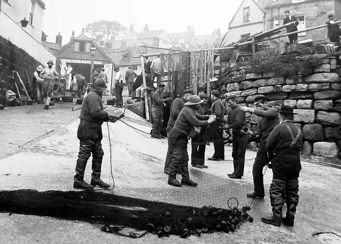 Framed Print : Robin Hoods bay repairing the nets Framed Print : Robin Hoods bay repairing the nets
