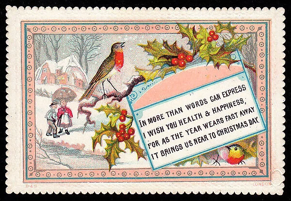 Robins and holly with snow scene on a Christmas card