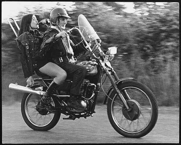 Rocker & Rock Chic. Rebellious teenagers on a motorbike in Charlwood, Surrey