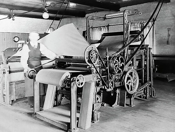 Rolling and cutting cloth in a woollen mill in Bradford